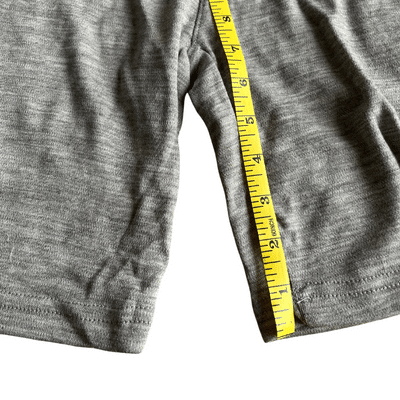 Seven Inch of Gray Woolly Shorts Measured With a Measuring Tape